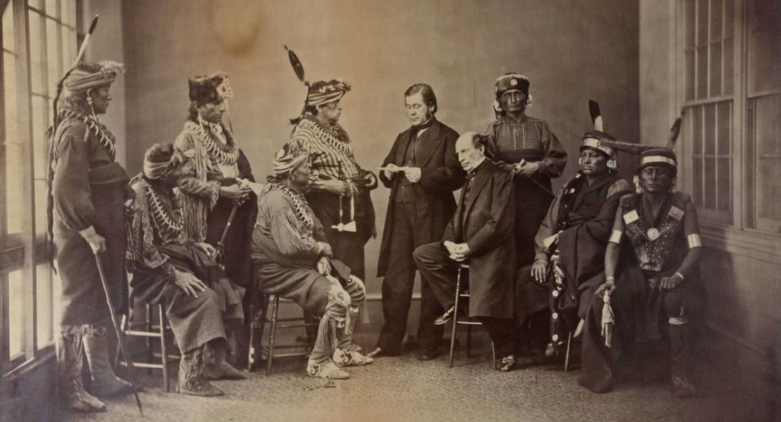 Lewis Bogy (standing at center, holding paper), commissioner of Indian affairs from 1867–1868, with members of the Sac and Fox nations. [Missouri Historical Society, St. Louis, Photographs and Prints Collection, N45494]
