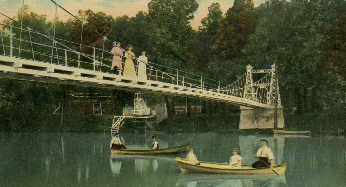 A steel swinging suspension bridge connected both sides of the park. Several types of watercraft were available for the public’s use on the lake. [State Historical Society of Missouri, Lynn Morrow Papers (R1000)]