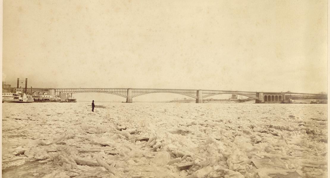 A man stands on an ice gorge with Eads Bridge in the background on January 10, 1875. [Missouri Historical Society, St. Louis, Photographs and Prints Collection, N13897]