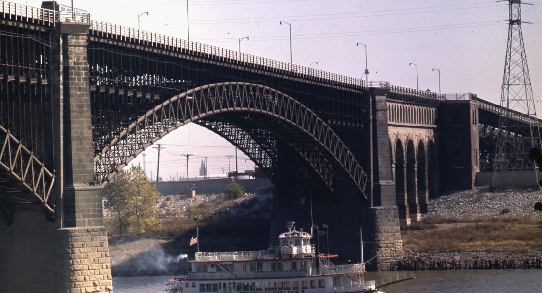 The steamboat Huck Finn passes under Eads Bridge in 1963. [Arthur Witman Photograph Collection (S0732), State Historical Society of Missouri]