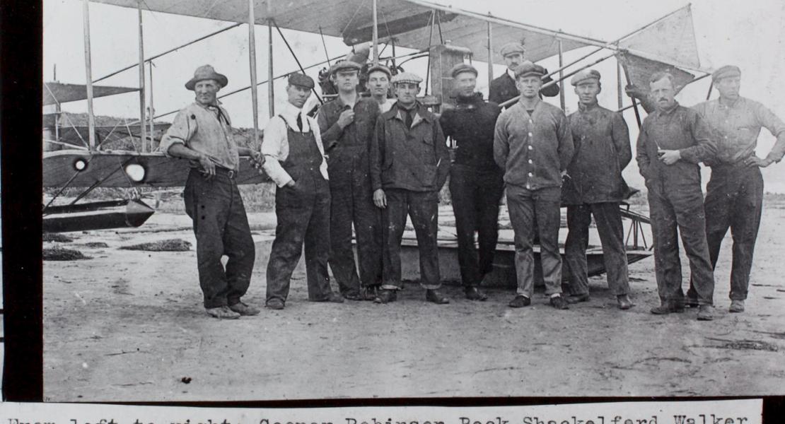 Left to right: John D. Cooper, Hugh Robinson, Paul W. Beck, William J. “Shack” Shackelford, John C. Walker Jr., Charles Witmer, Glenn Curtiss, Theodore G. Ellyson, R. H. “Lucky Bob” St. Henry, George E. M. Kelly, and George B. “Slim” Purington at the Curtiss Aviation Camp, North Island near San Diego, March 10, 1911. [Courtesy of the San Diego Space-Air Museum Archives]