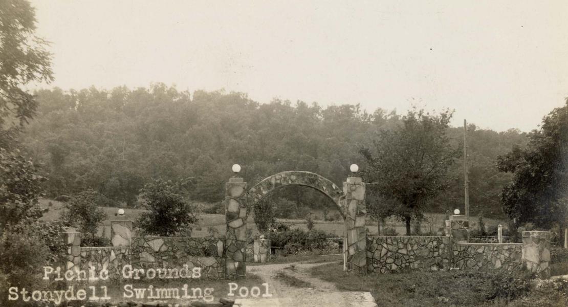 Vern Prewett added the picnic grounds a few years after building the cabins, bathhouse, and pool. It offered swings and a teeter board for children as well as picnic tables. [State Historical Society of Missouri, John F. Bradbury Postcard Collection, R1551]
