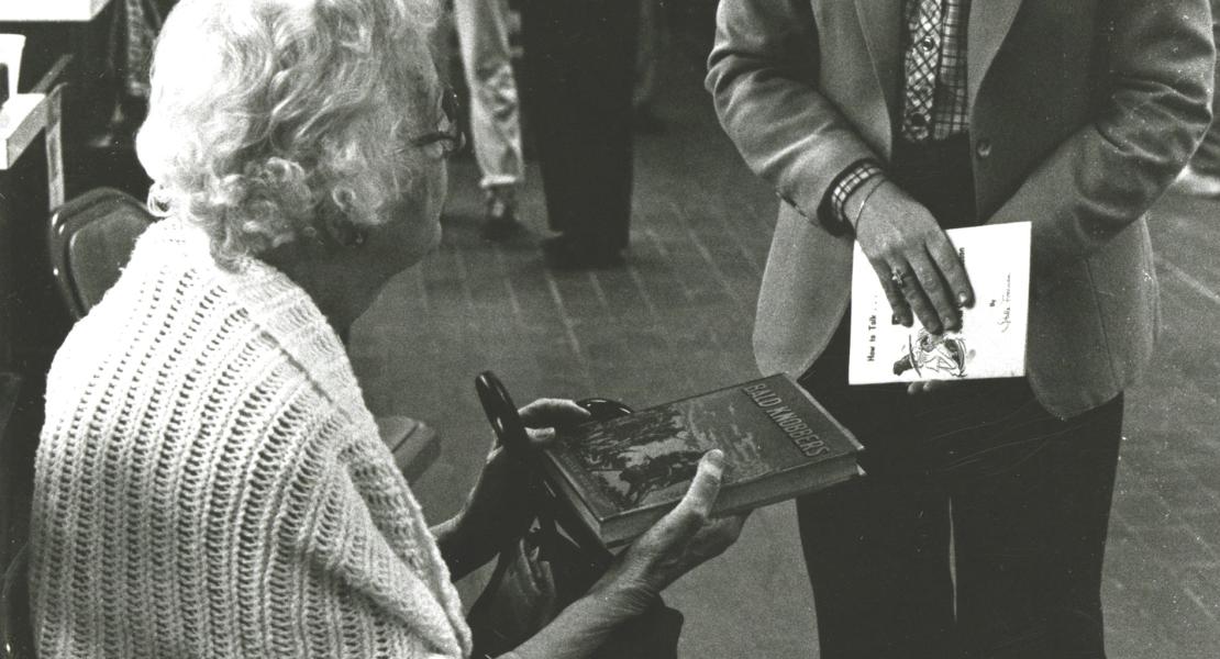 Lucile Morris Upton signing a copy of her book in 1982. [State Historical Society of Missouri, Lucile Morris Upton Papers, C3869]