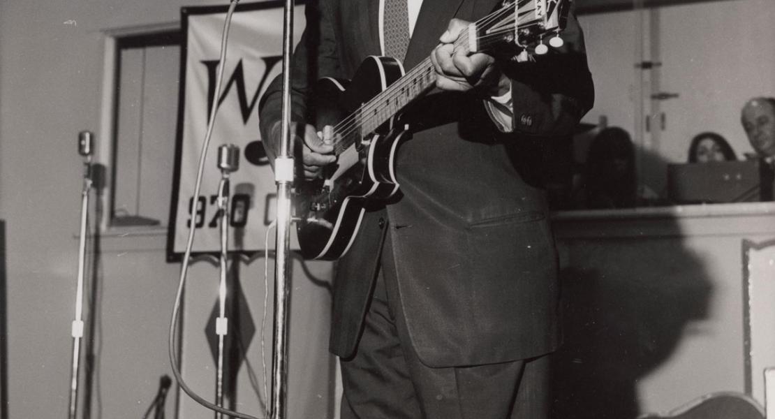 Lonnie Johnson performing in 1965 at the Folk Festival Show, Palisades Amusement Park, New Jersey. [Cornell University Library, Division of Rare and Manuscript Collections, Amsterdam News Photograph Archive, #8084]